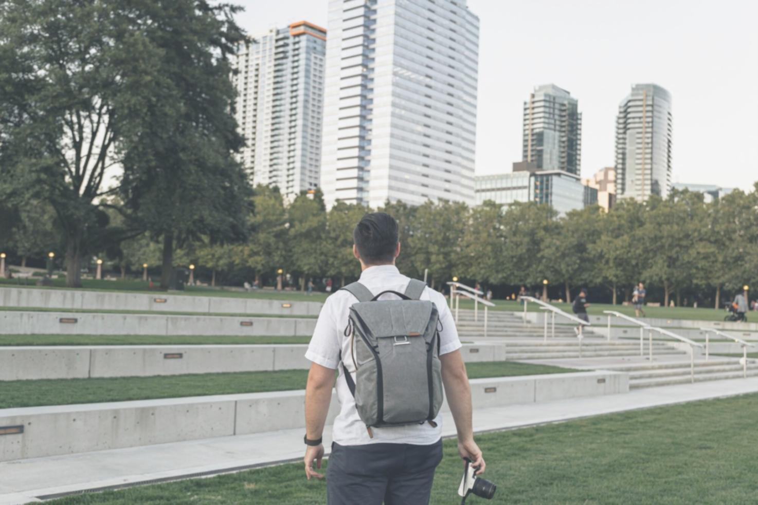 Financial analysis workspace showing multiple monitors with charts, graphs, and spreadsheet data being analyzed by professionals