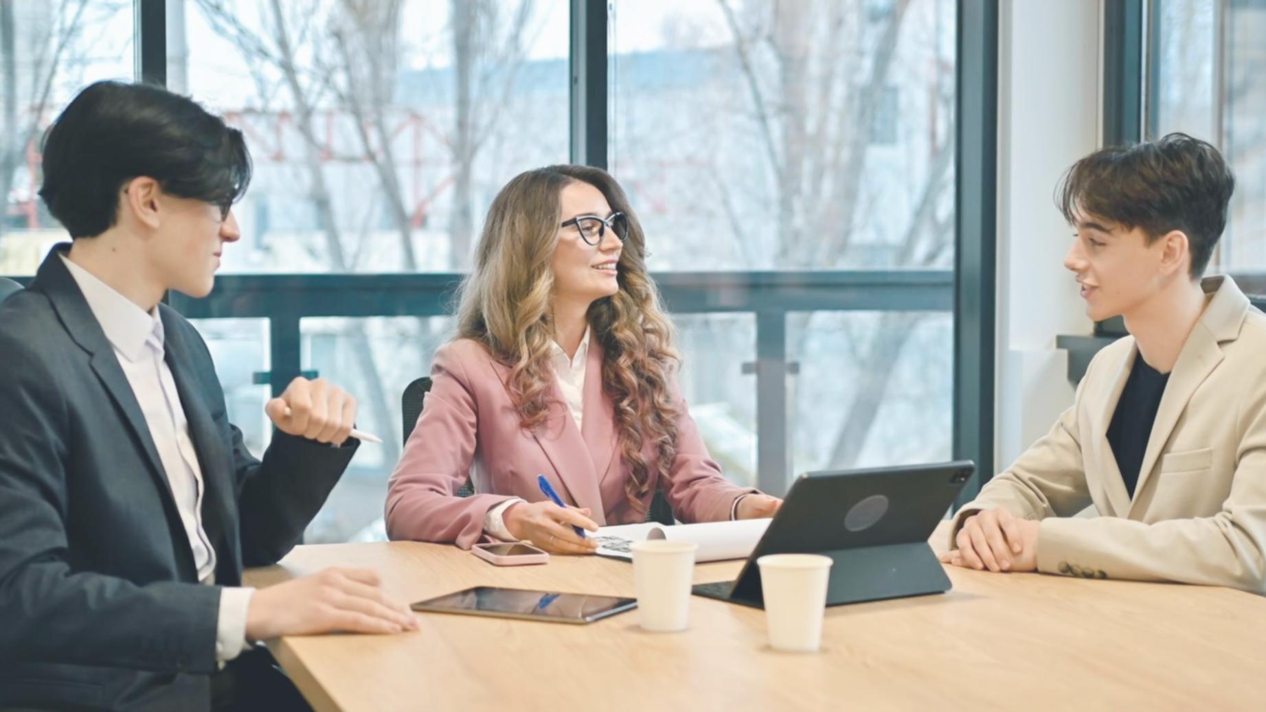 Small group financial planning session with charts and calculators